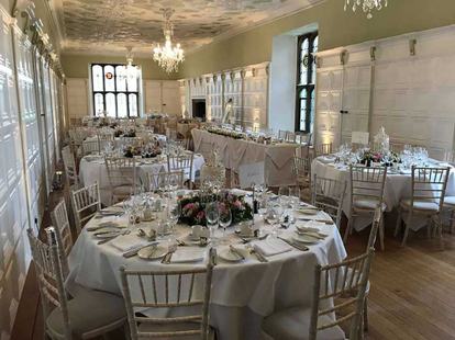 The banqueting hall at Hengrave Hall set for dinner at Kirsty and Adam's wedding